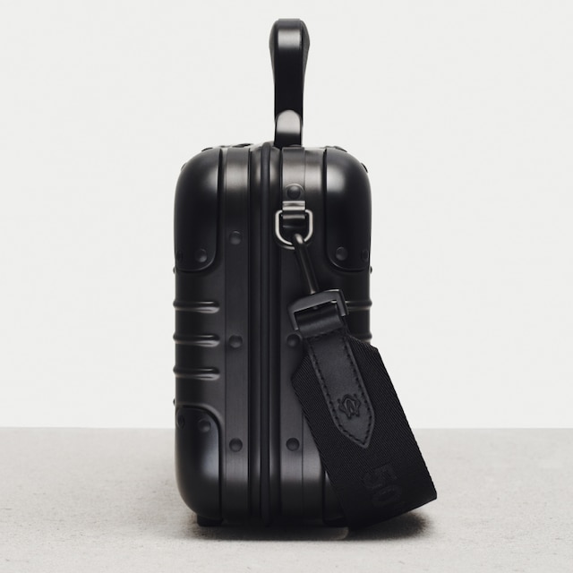 Close-up of the buckle strap on the Original Bag exterior in black