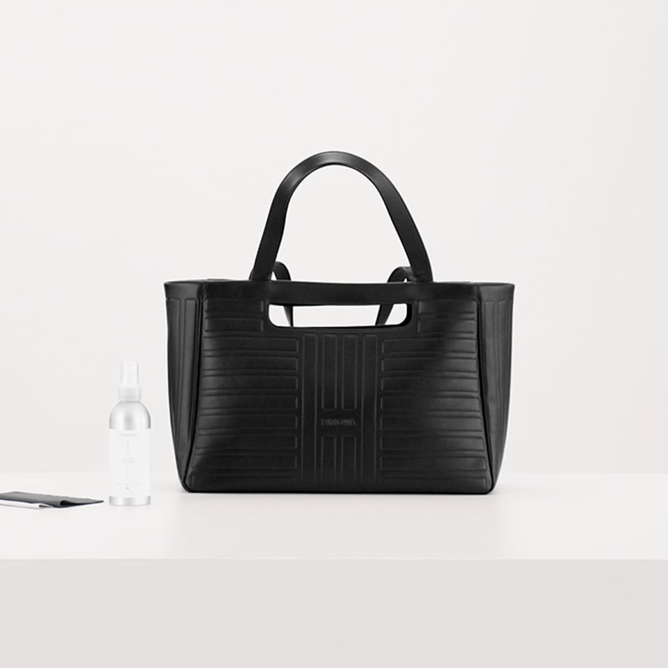 Cleaning a leather bag with RIMOWA Leather Care Spray