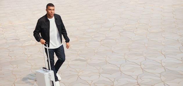 Kylian Mbappé with a Classic Cabin suitcase in silver