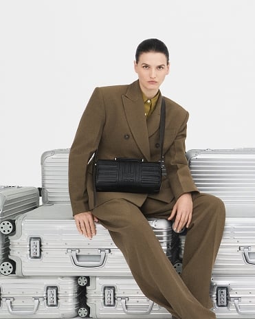 RIMOWA Groove Cross-Body Bag Small - A designer bag in leather featuring RIMOWA's iconic grooves