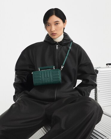 RIMOWA Groove Cross-Body Bag Small - A designer bag in leather featuring RIMOWA's iconic grooves
