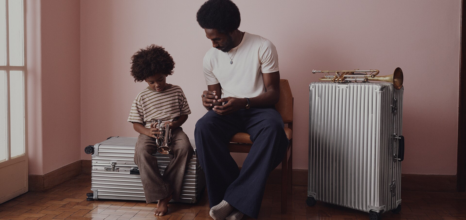 Picture of a father and his son looking at a trumpet